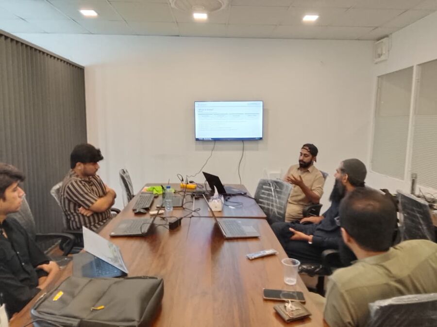 A mentor leading a discussion around a meeting table